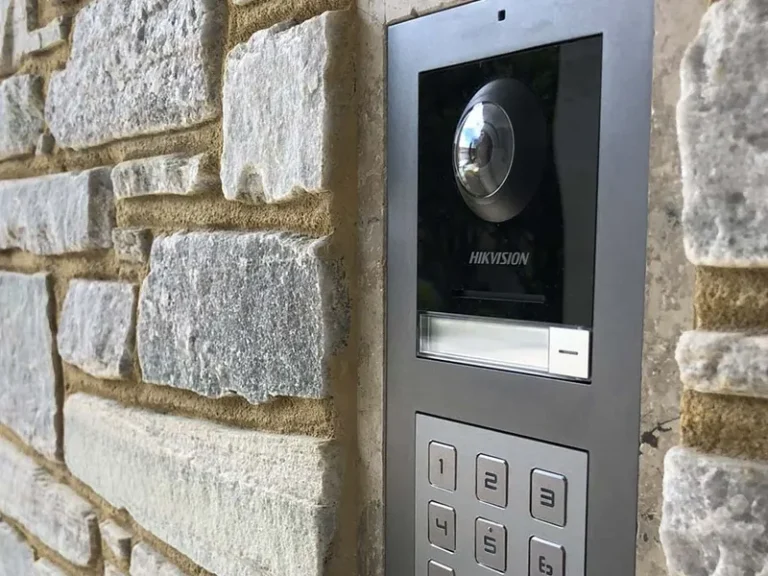 Intercom and access control installation featuring a wall-mounted video intercom unit with integrated camera, installed as part of a residential and multi-unit development project to support secure access and coordination across electrical and communications infrastructure.