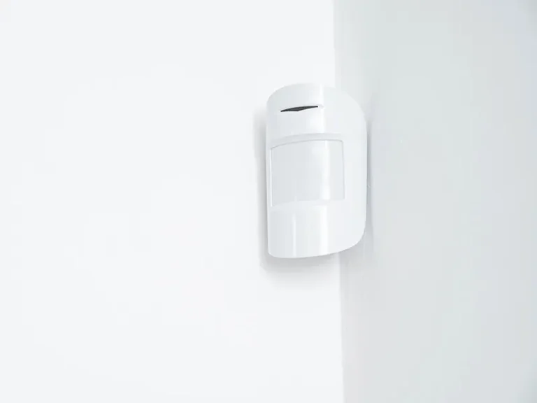 Residential alarm and monitoring system installation in Perth featuring a wall-mounted motion sensor integrated into new-build and multi-unit security plans with real 24/7 Australian monitoring.