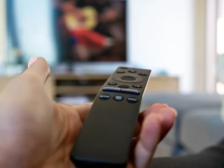 User navigating a newly installed MATV system on a television as part of TV antenna and free-to-air distribution work, including antenna alignment, signal distribution hardware and property-wide TV point installation for a residential project in Perth.